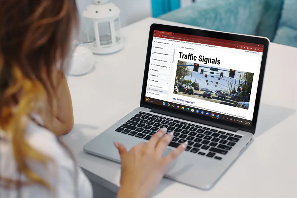 The online course open on a laptop, showing a traffic signals lesson