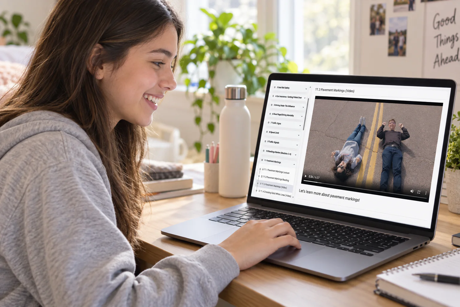 A student watching a pavement markings video lesson in the online course