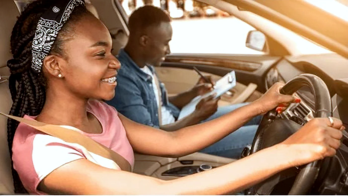 Student driving with an instructor during a behind-the-wheel lesson