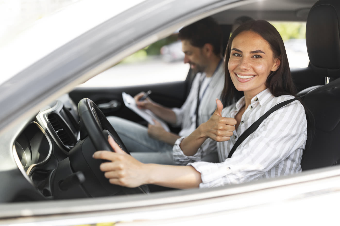 An Arkansas student at the wheel with her instructor