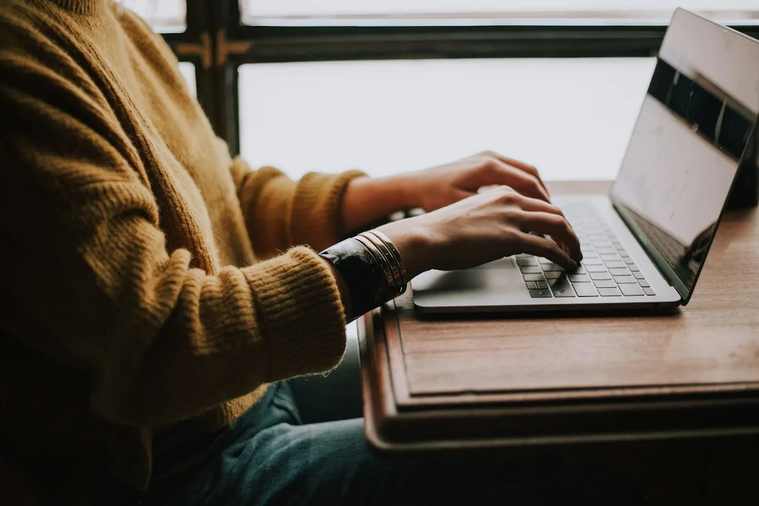 A student studying the online course on a laptop