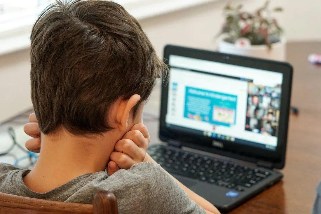 A student working through the online course on a laptop
